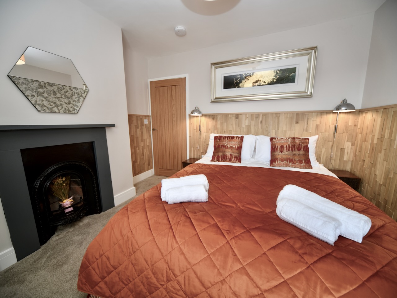 Master bedroom at Gardeners cottage with view of original victorian fireplace