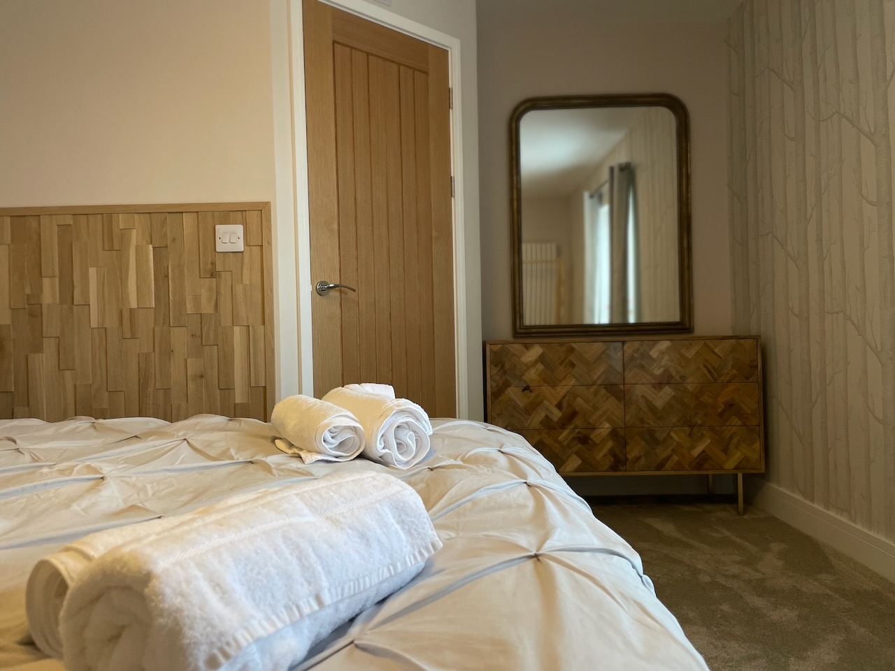 Feature full height mirror and mango wood drawer unit in master bedroom