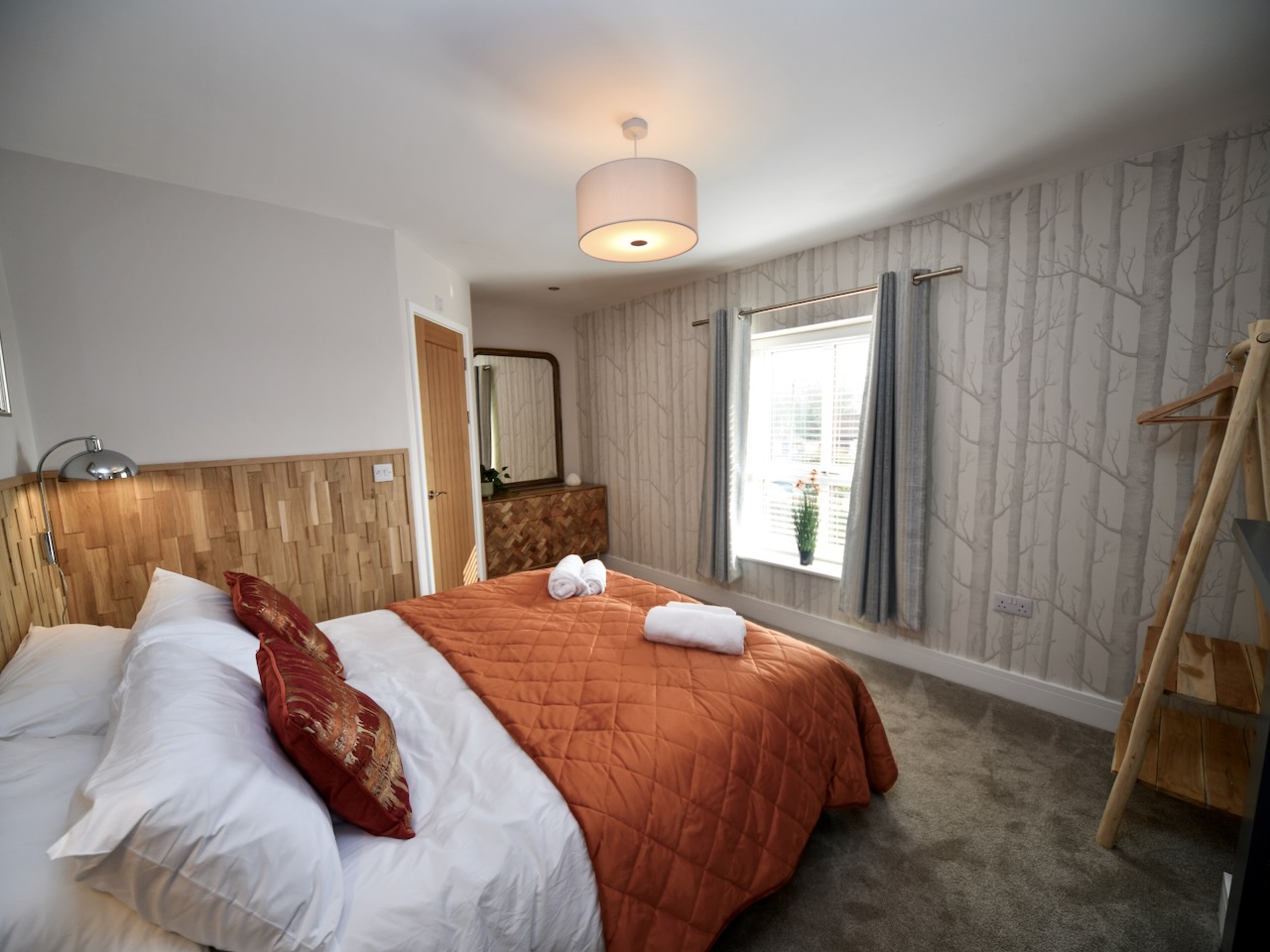 Master bedroom looking towards feature mirror and ensuite