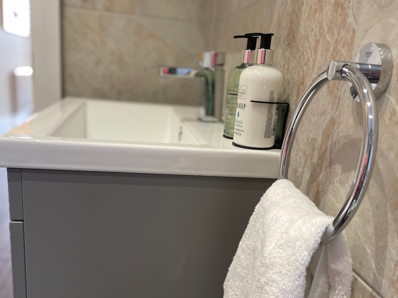 Sink with complimentary toiletries in downstairs bathroom